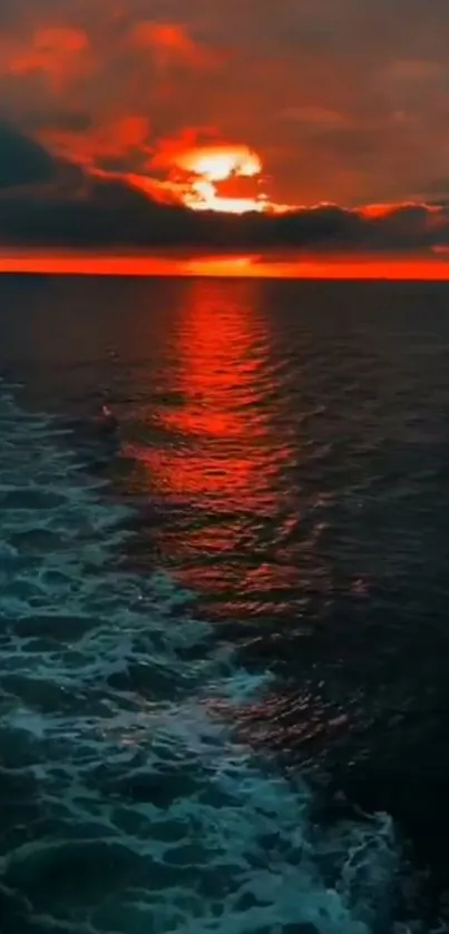 Orange sunset over ocean with reflecting waters.