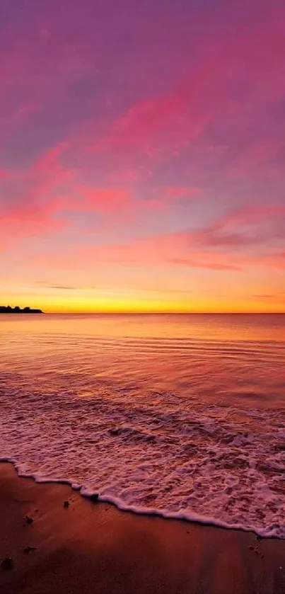 Vibrant ocean sunset with purple sky and calm waves on a serene beach.