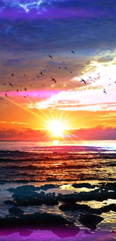 A breathtaking sunset over the ocean with birds flying in a vibrant, colorful sky.