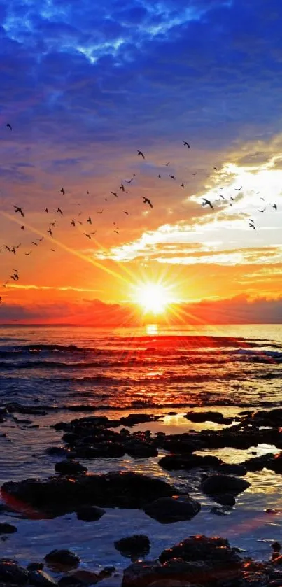 Majestic ocean sunset with vibrant sky and flock of birds.