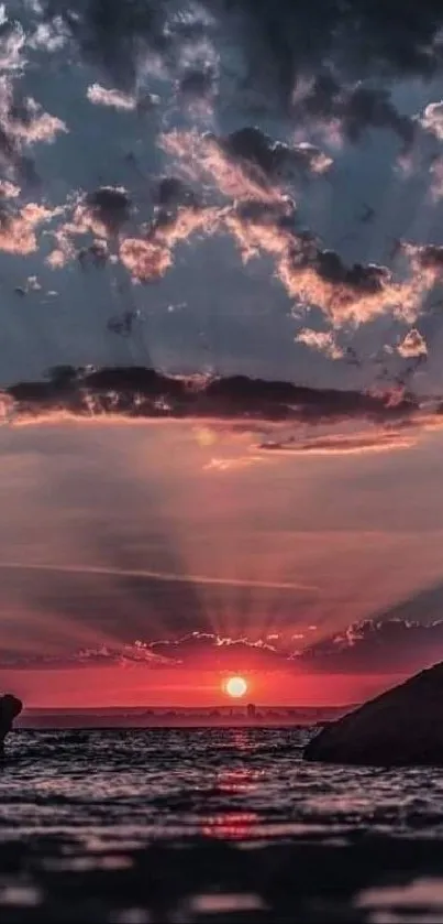 Gorgeous sunset over the ocean with dramatic clouds and colorful sky reflections.