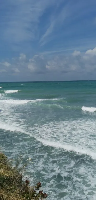 Breathtaking ocean view with waves and a clear blue sky.