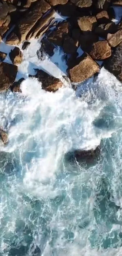 Aerial view of ocean waves crashing on rocky shoreline.