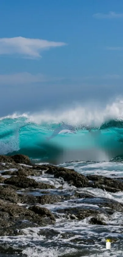 Turquoise wave crashing over rocks under a clear sky.