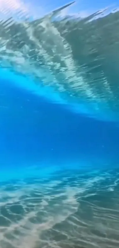 Underwater view of a vibrant blue ocean wave, showcasing natural beauty.