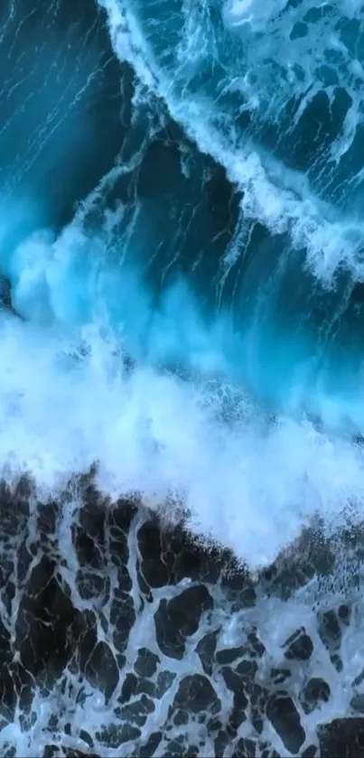 A mesmerizing blue ocean wave crashing against the shore, captured from above.