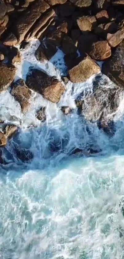 Aerial view of ocean waves crashing on rocks.