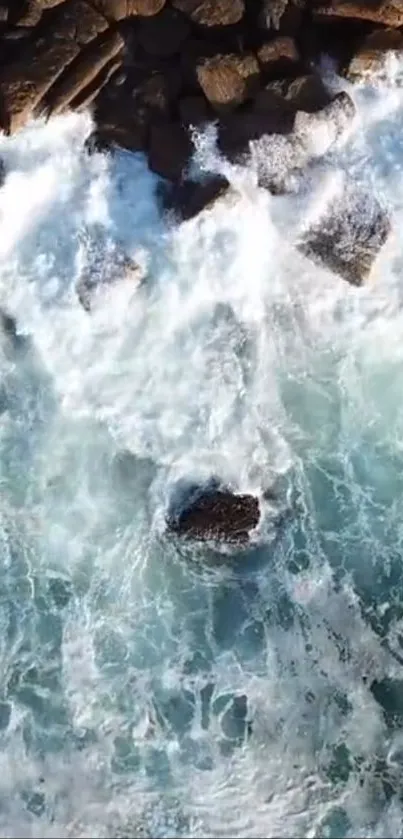 Aerial view of ocean waves crashing against rocks.