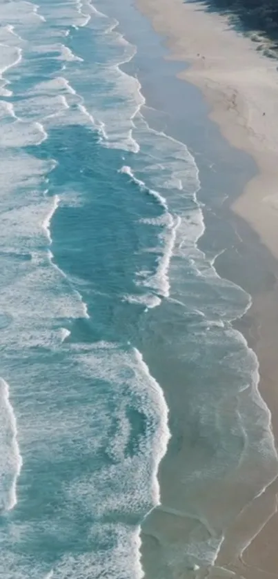 Aerial view of ocean waves meeting sandy shores.