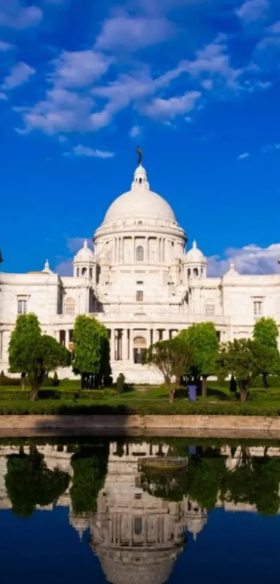 Ornate palace with a stunning reflection under a vibrant blue sky.