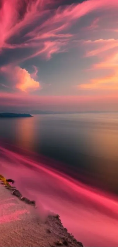 Vibrant pink sunset over a calm beach.