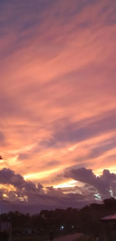 Serene pink sunset sky with clouds and evening colors.