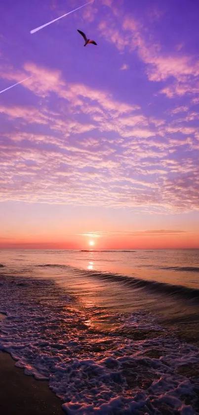 Purple sunset over ocean waves with a tranquil beach scene.