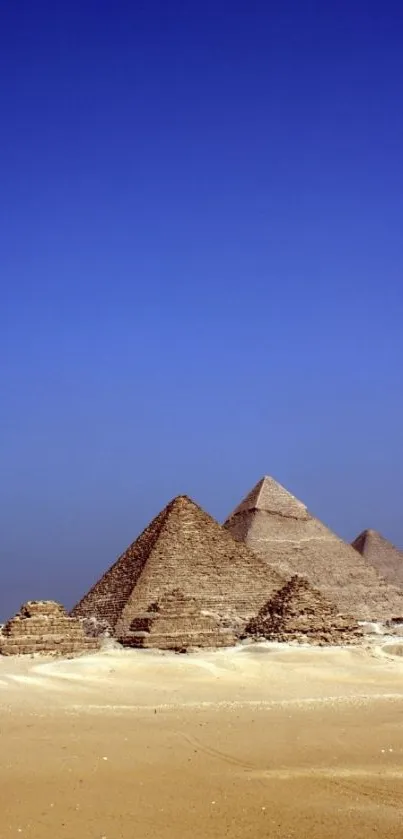 Pyramids under a clear blue sky with desert sands