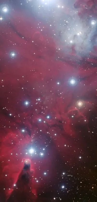 Red galaxy full of stars with glowing nebula clouds.