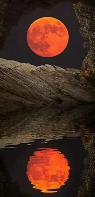 Red moon reflecting in water framed by rocky cave.