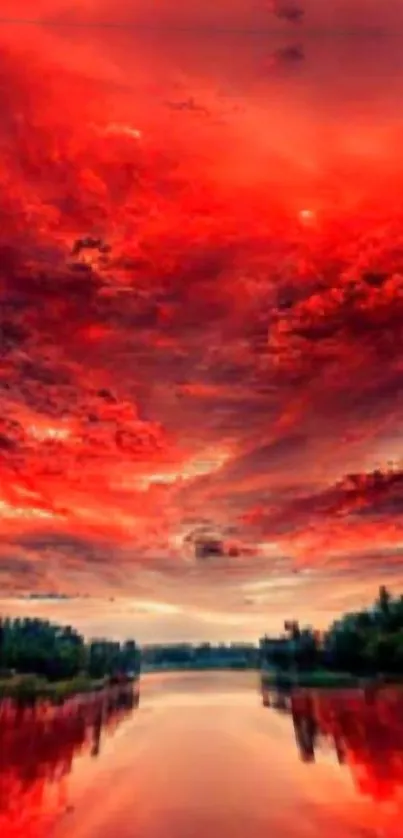 A stunning red sunset sky over a serene lake with dramatic clouds.