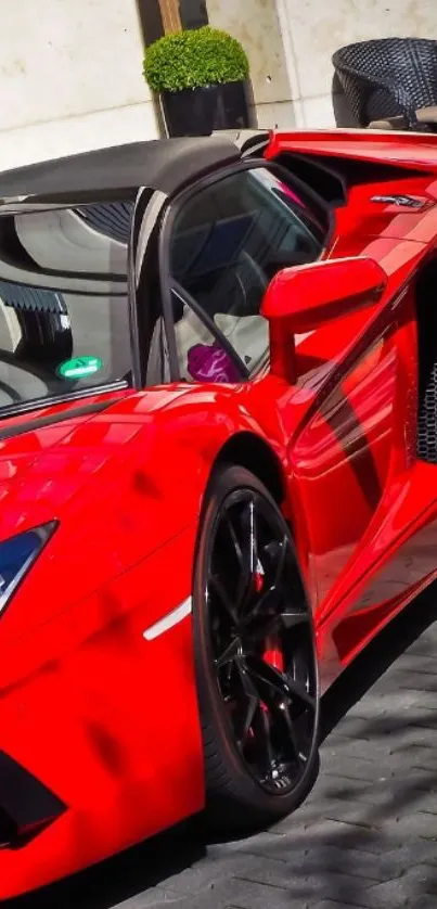 Vibrant red sports car parked outside.