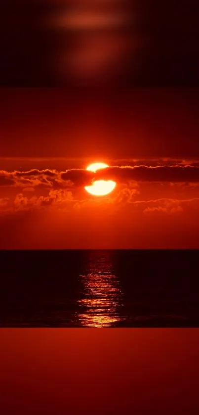 Vivid red sunset over an ocean with reflection.