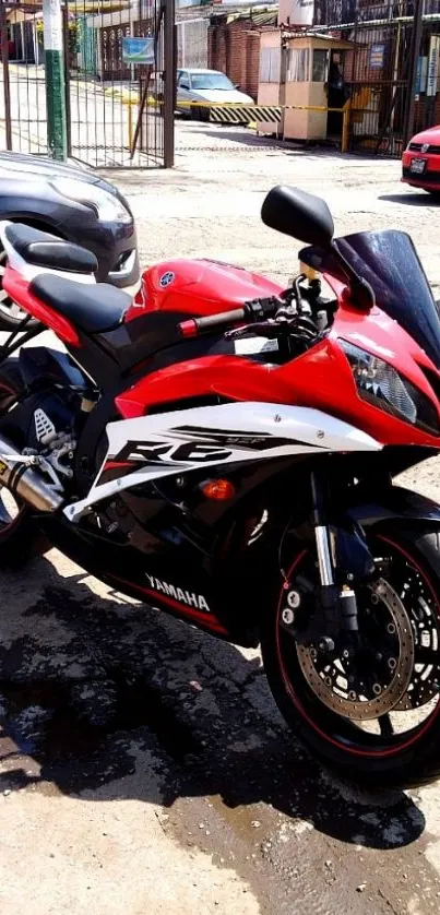 Red Yamaha motorcycle parked on a city street, ready for a ride.