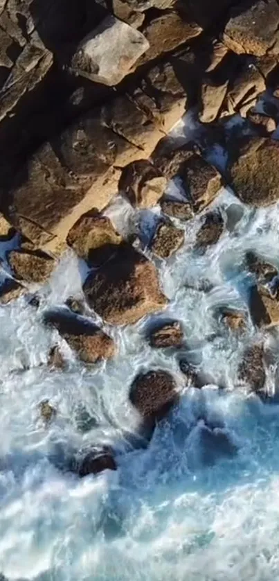 Aerial view of ocean waves crashing over rocky coastline.