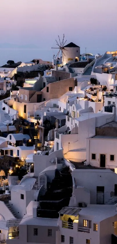 Santorini nightscape with white buildings and a tranquil sunset.