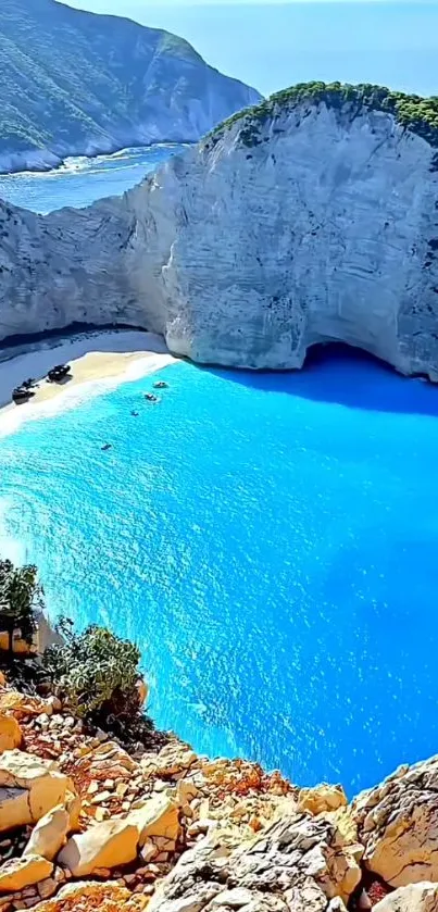 A stunning seaside cliff with bright blue waters and green cliffs.