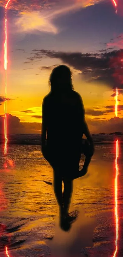 Silhouette of person on the beach at sunset with vibrant sky.