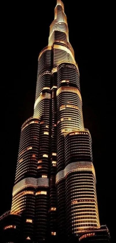 A stunning skyscraper illuminated at night, perfect for a mobile wallpaper.