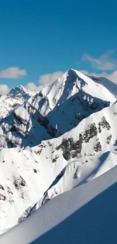 Snowy mountain peaks under clear blue sky.