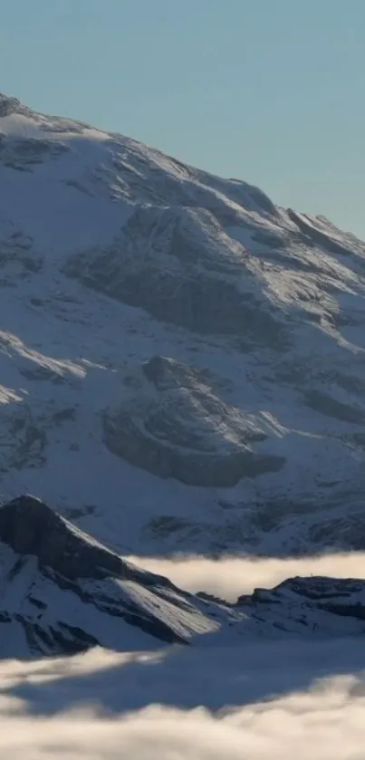 Snow-covered mountain with serene sky.