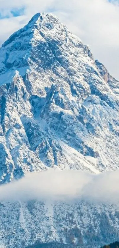 Snowy mountain peak against blue sky wallpaper.