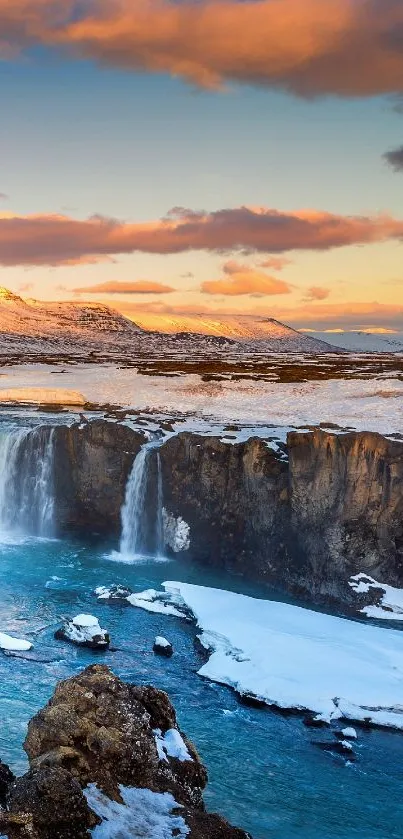 Snowy waterfall with sunset sky, serene nature mobile wallpaper.