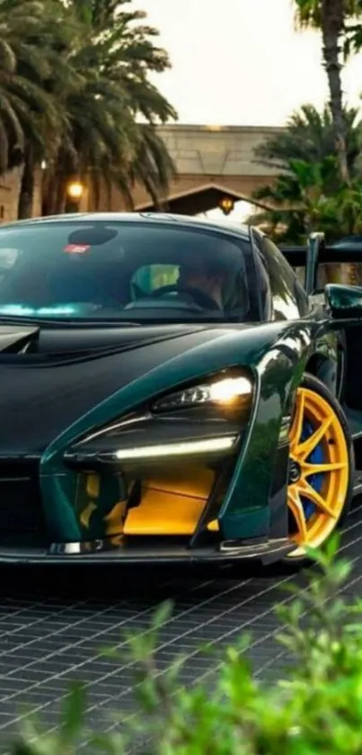 Green sports car with yellow wheels in a tropical setting.