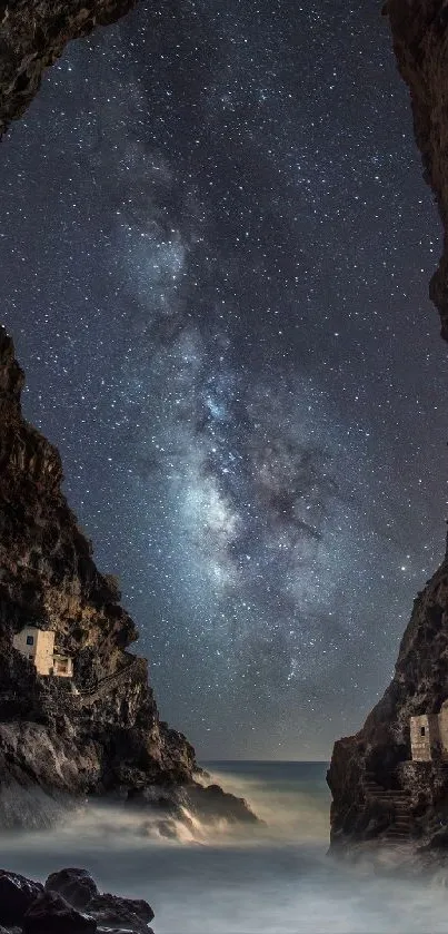 Breathtaking view of a starry sky framed by towering cliffs over a serene ocean cove.