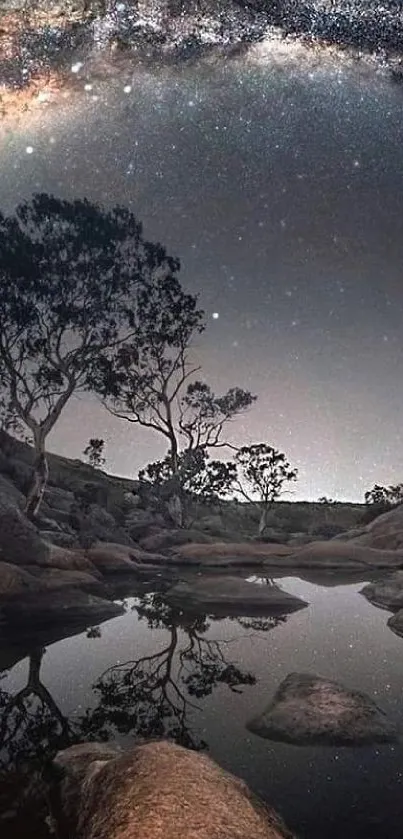 Starry night sky with trees and lake reflection.