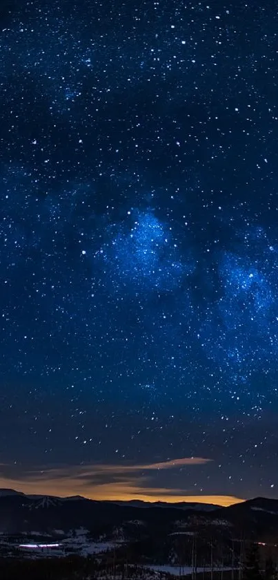 Starry night sky over mountains with Milky Way.