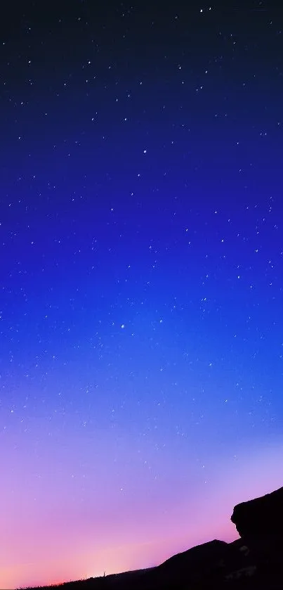 Captivating starry night with deep blue and purple gradient over a silhouetted skyline.