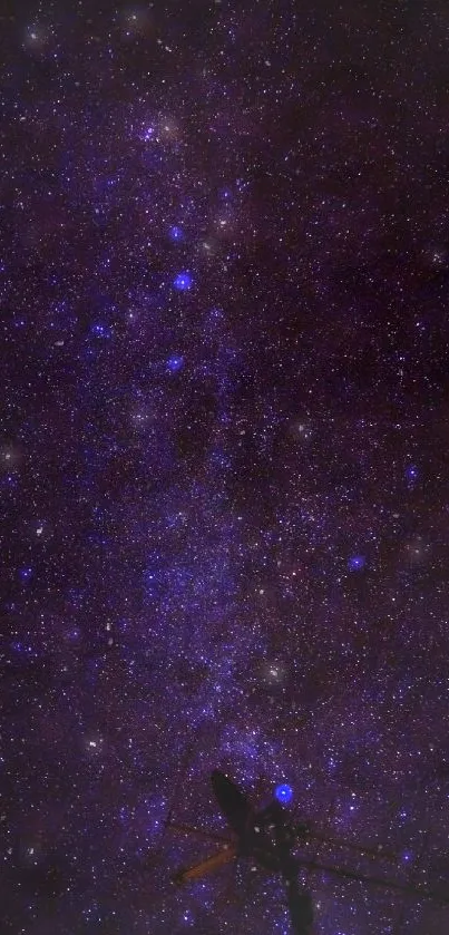 Purple starry night sky with a silhouette of an antenna.