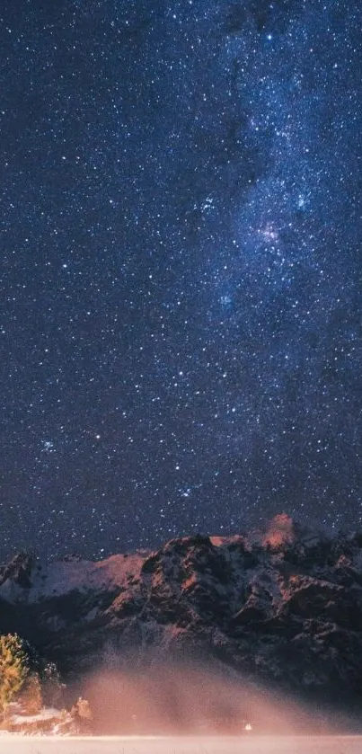 Starry night sky over misty mountains wallpaper.