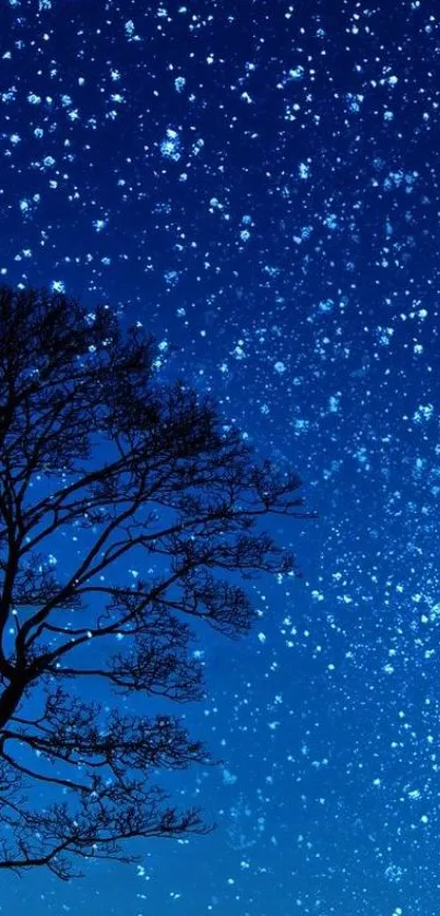 A captivating starry night wallpaper with a silhouetted tree under a dark blue sky.