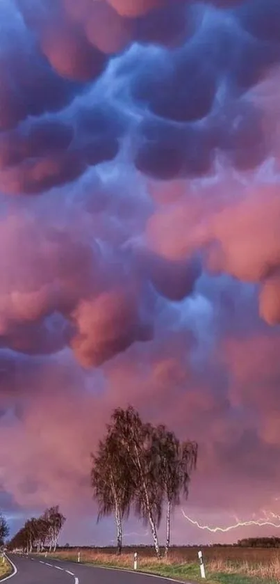 A dramatic sky filled with purple mammatus clouds over a winding road.