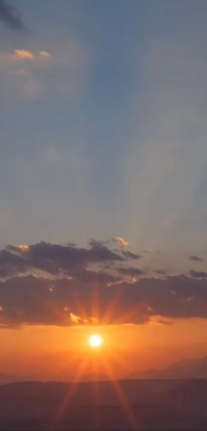 A stunning sunrise sky with vibrant orange hues and scattered clouds.