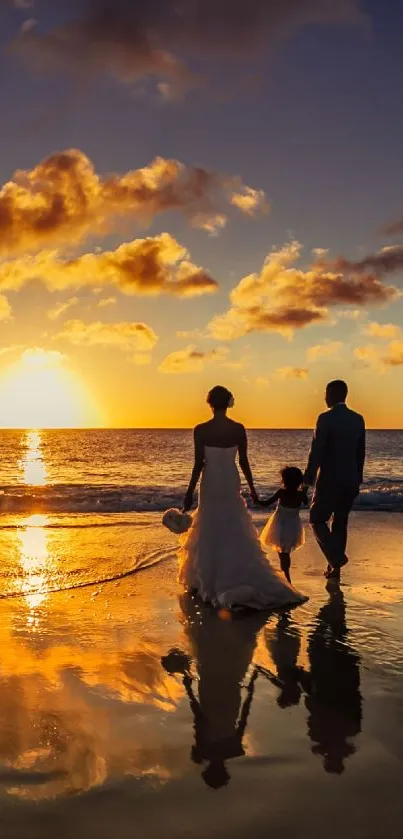 Family walking on beach at sunset with reflections.