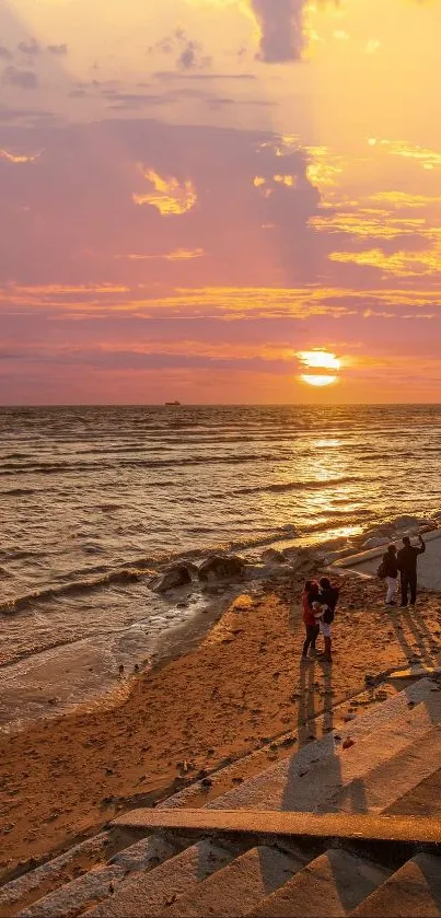 Orange sunset over a serene beach with gentle waves.