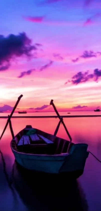 Tranquil boat on water with vibrant sunset sky.