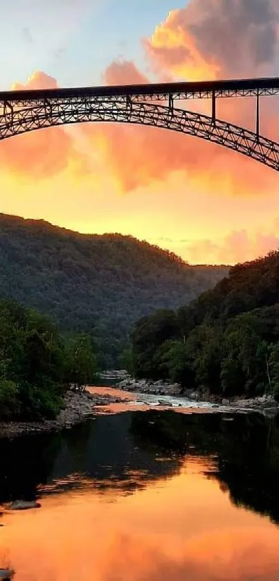 Sunset bridge over a river with scenic forest and vibrant sky.