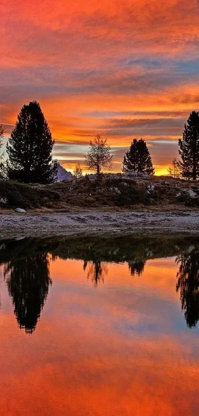 Beautiful sunset over lake with vibrant orange reflections and silhouetted trees.