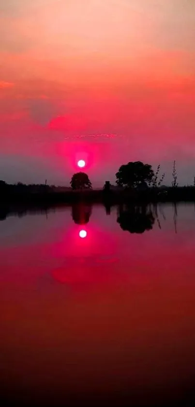 Serene sunset reflecting over a calm lake with deep red hues.