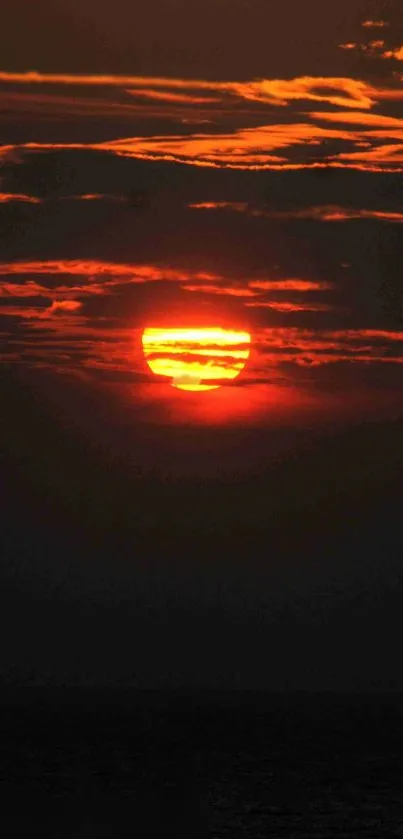 A stunning sunset with vibrant orange hues over a tranquil sea.